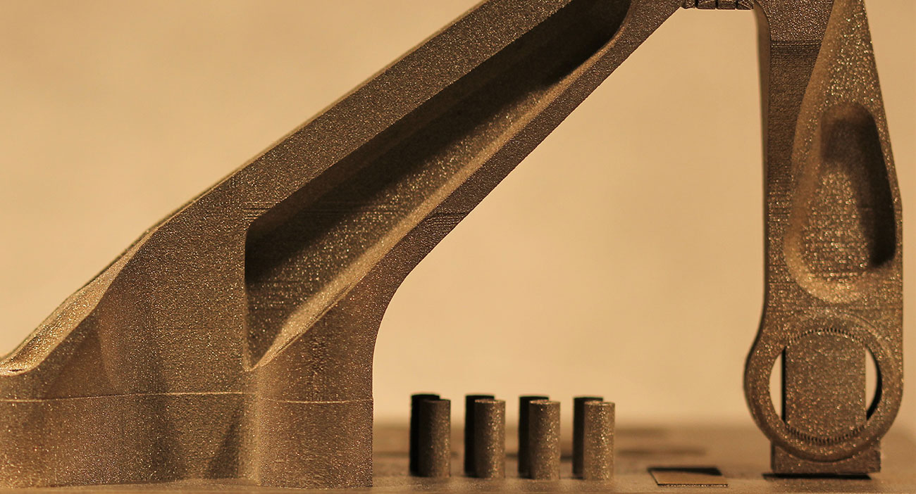 An additively manufactured metal bracket and test specimens